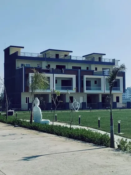 A wider perspective of the row houses and the expansive community lawn. Our planning ensures ample open space, promoting an outdoor lifestyle and providing unobstructed views for the residences.