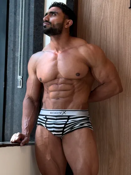 Chale aana. A relaxed pose by the window, showing my ab definition.