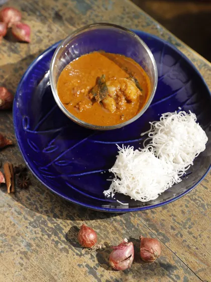 Ulli Theeyal is a bold and complex dish featuring caramelized roasted coconut, tamarind, and slow-cooked shallots. Its deep, smoky flavor and tangy finish make it an unforgettable side dish for any meal.