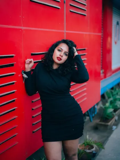 A duplicate of image 30, this shot uses a bold red background to create a high-impact, modern fashion portrait.