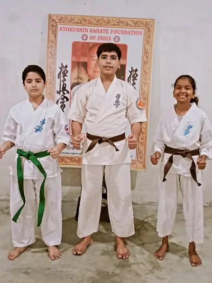 My senior students, two brown belts and a green belt, ready to take on new challenges.
