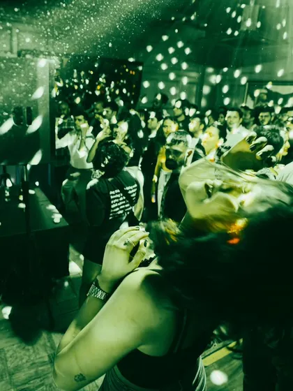 The disco ball working its magic, scattering light over the dancing crowd.