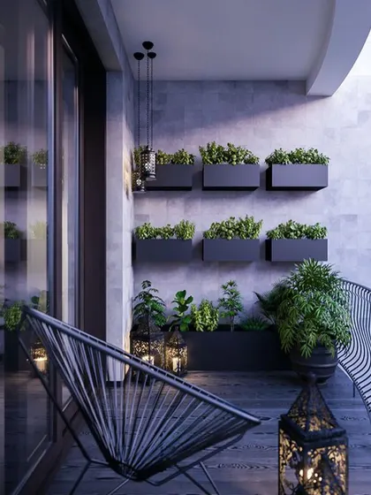 A clean and modern balcony design. The use of wall-mounted planters for a vertical garden saves floor space, while the minimalist chair and lanterns add a touch of style.
