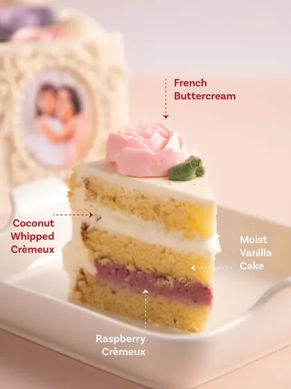A slice of heaven. This shows the beautiful layers of our special vanilla cake with coconut whipped crémeux and raspberry crémeux.