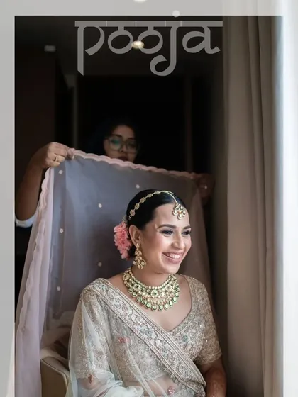 A behind-the-scenes moment of the bride getting her veil adjusted, her joyful smile lighting up the frame.