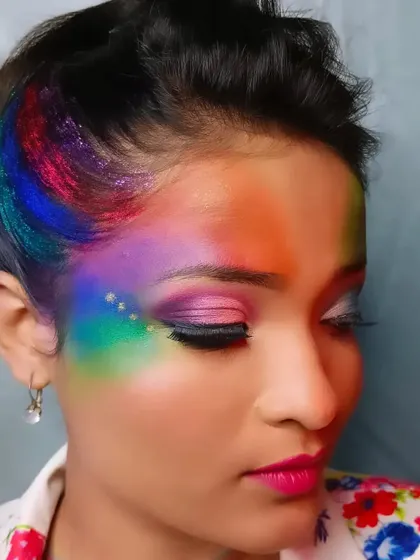 This shot gives a clear view of the rainbow effect on the face and the precise blending of the eye makeup.