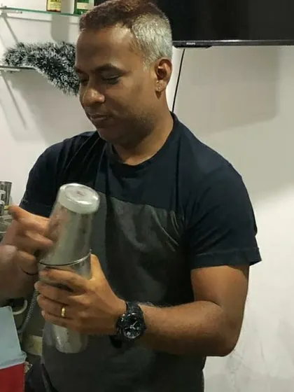 Focused on the craft, shaking up a cocktail during a private session. Each movement is precise, ensuring the drink is perfectly chilled, diluted, and mixed.