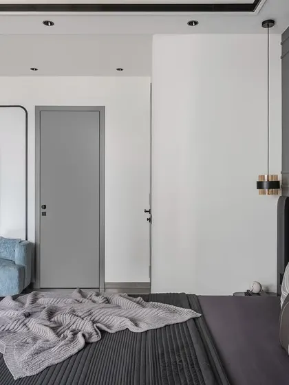 A comfortable blue couch creates a cozy reading nook within the master bedroom. This versatile addition provides a perfect spot for relaxing with a book or enjoying a quiet moment away from the main living areas.