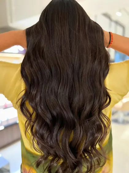 Fun peek-a-boo highlights in a two-tone blend on long hair. This technique adds a subtle surprise of color, paired with a face-frame haircut for style.