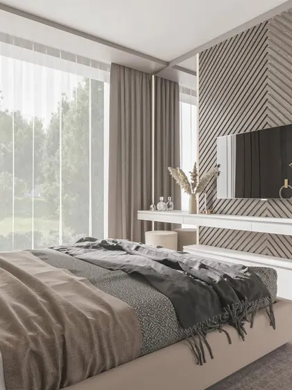 Another angle of the bedroom with the chevron accent wall, highlighting the natural light from the large window and the room's calm, earthy tones.