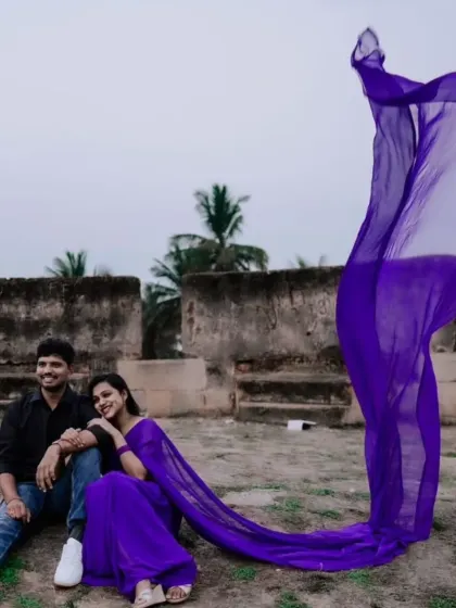The long trail of this pre-stitched purple saree creates a beautiful, dramatic effect, perfect for creative couple photoshoots.