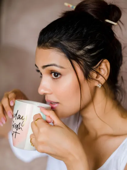 A close-up on the expression, showing a moment of quiet contemplation. The natural makeup look is fresh and beautiful.