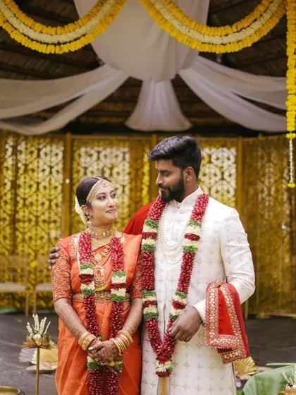 A classic portrait of Sneha and Pranav after their ceremony, adorned with beautiful garlands. Their matching smiles reflect their happiness.