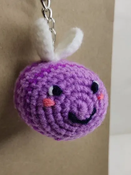 A purple-striped bumblebee keychain.