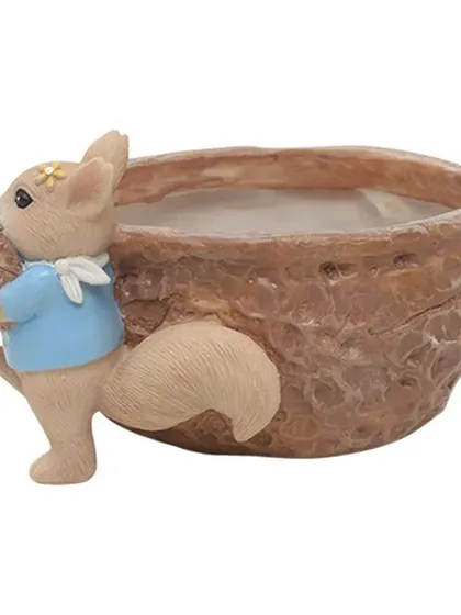 A closer look at the details on our squirrel nut pot. It's crafted from durable resin and adds a whimsical touch to any indoor or outdoor space.