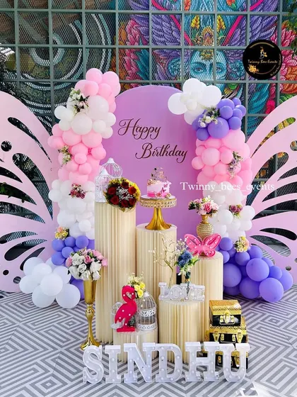 A beautiful butterfly-themed birthday for Sindhu. We used large, elegant butterfly wing cutouts as the main backdrop, surrounded by pastel balloons and floral arrangements on classic pedestals.