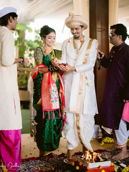 The couple performing rituals together by the sacred fire.