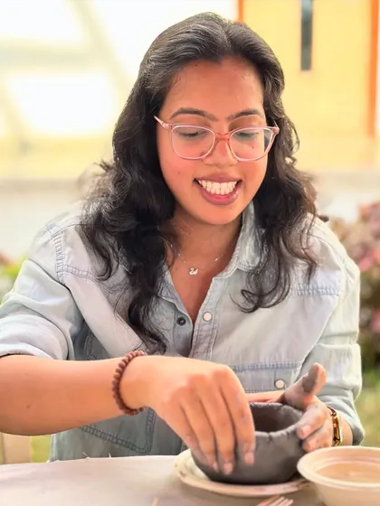 The joy of making something with your own hands is universal. A smiling participant from the Tata Memorial Centre enjoying a sunny afternoon of creativity.