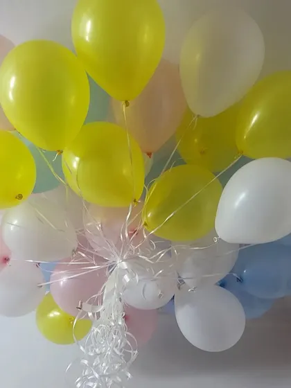 A bunch of pastel-colored helium balloons ready for a party.