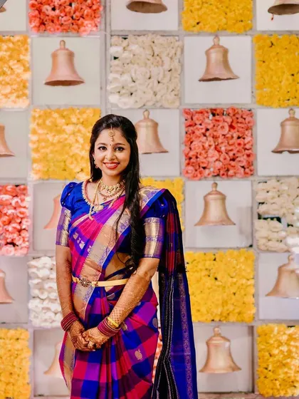 A beautiful portrait of the bride. Her multi-colored saree is so unique, and the makeup complements it perfectly.