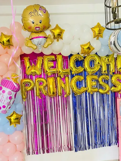 A closer view of the "Welcome Princess" foil balloon banner and the surrounding balloon decorations.