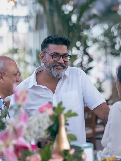 A candid moment of conversation during a gathering. I strive to create an atmosphere where guests feel at ease and can connect authentically.