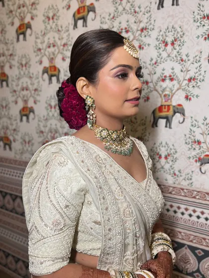 Another beautiful side profile, showcasing the neat, polished bun and the subtle glow of her makeup.