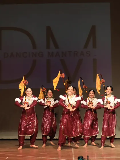 The Bhangra Queens in a powerful starting pose with their props, ready to mesmerize the 'City of Stars' audience.