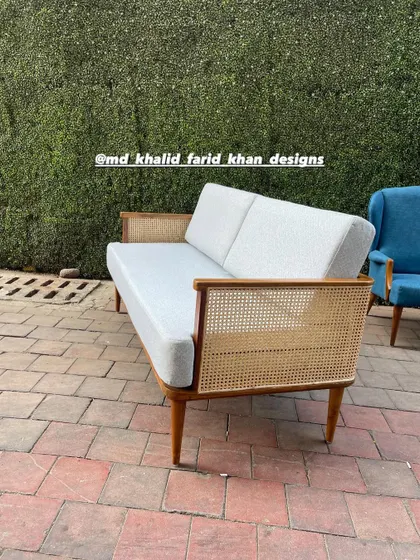 A three-quarter view of the sofa, showcasing its clean lines and tapered wooden legs.
