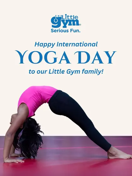 A young girl demonstrates a perfect wheel pose in celebration of International Yoga Day, inviting families to experience our mindful movement classes.