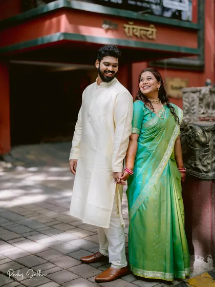 A happy, candid shot of Nidhi and Aditya holding hands during their engagement.