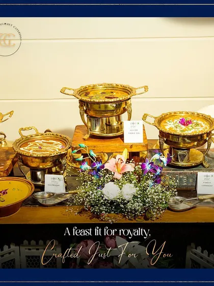 The text "A feast fit for royalty" perfectly describes this display of Indian main courses. Served in ornate brass dishes and decorated with flowers, the setup exudes opulence and tradition.