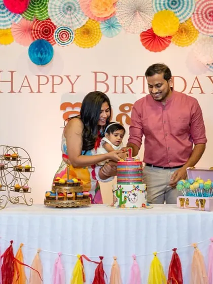 A colorful and festive birthday party with a backdrop of paper fans and a tassel garland. This shows our ability to create beautiful decor for any theme.