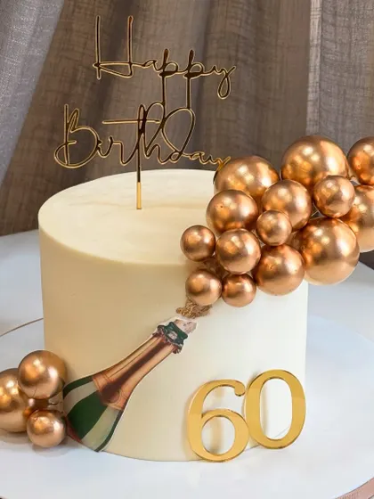 Popping into 60 like a celebration in full swing! This champagne-themed cake is all about glam, with golden bubbles and a chic design that feels truly fabulous.