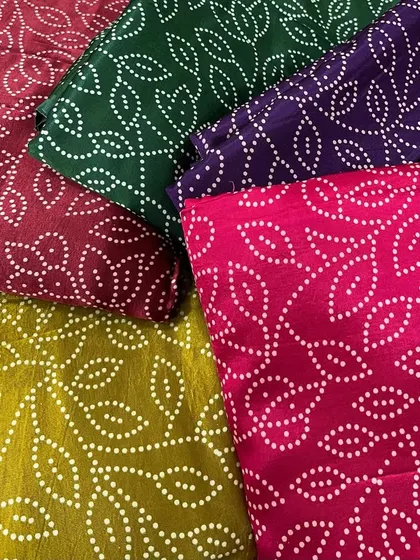 A collection of our Gajji Satin prints in various bold colors. The traditional dotted leaf pattern and silky finish make them a festive favorite.