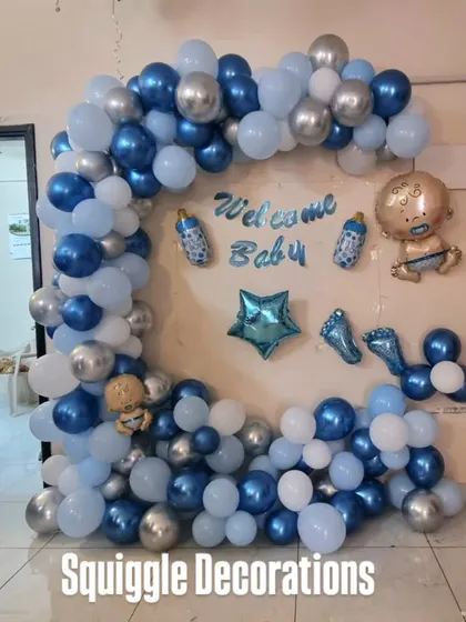 A 'Welcome Baby' balloon arch in shades of blue and silver, perfect for a baby boy's welcome home celebration.