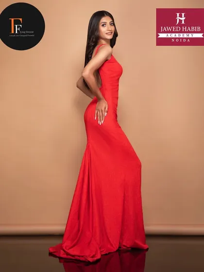A full-length shot of a model in a red gown from a fashion shoot, where our students got hands-on experience with professional models.