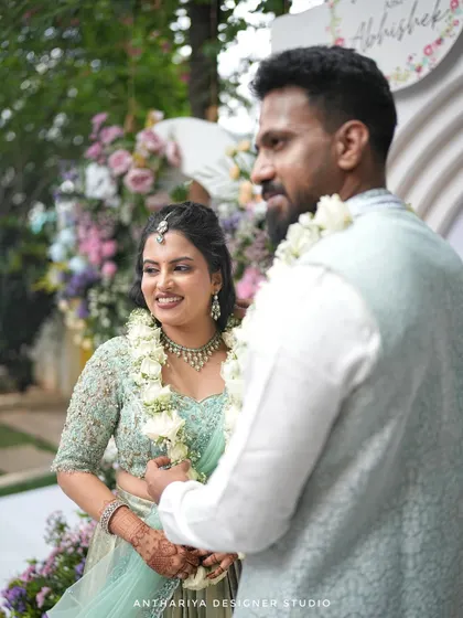 The couple sharing a happy moment during their engagement ceremony.