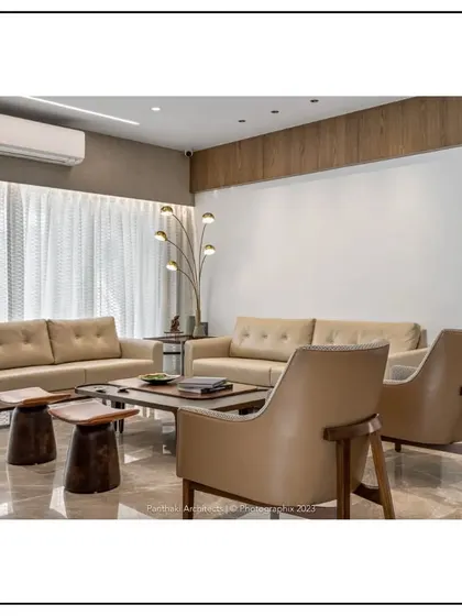 In this living space, we paired contemporary sofas with rustic wooden stools as side tables, demonstrating our eclectic style. The design balances modern clean lines with natural, textured elements for a unique and comfortable feel.