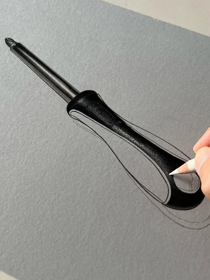 Here I am adding white highlights to the handle of the screwdriver drawing. This final touch creates the illusion of a shiny, three-dimensional object on a flat piece of paper.