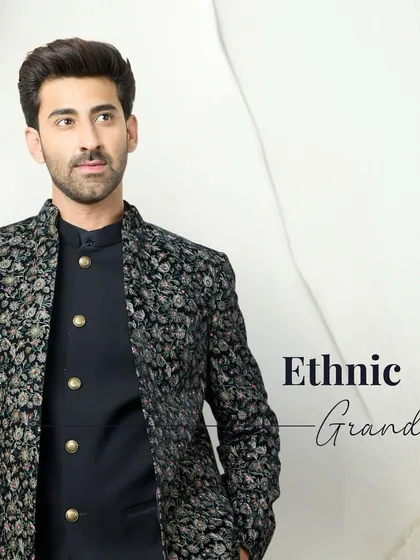 Ethnic grandeur in a two-piece set. A black kurta is layered with a jacket featuring intricate floral embroidery, creating a look of timeless sophistication.