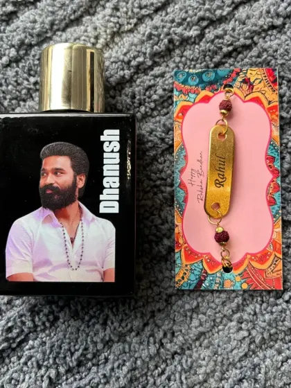 A perfect Rakhi gift for a movie fan. This combo features a Bella Vita perfume bottle with a custom photo and name, paired with a personalized Rudraksh rakhi.