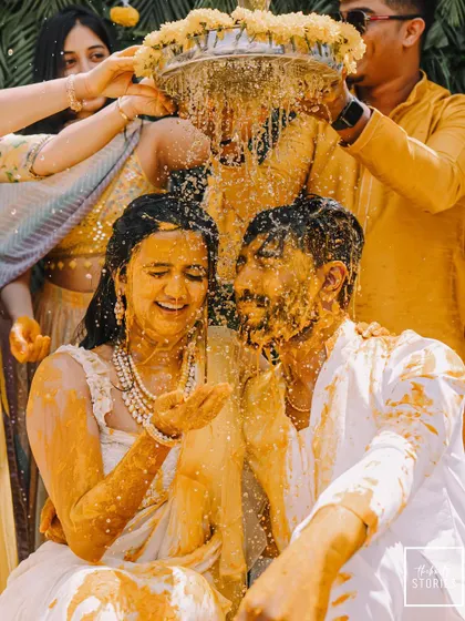 Another joyous moment from the Haldi ceremony, with the couple being showered with turmeric water and flower petals by their loved ones.