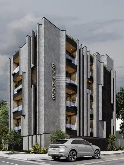 The 'Evance' apartment building showcases a sophisticated interplay of gray stone cladding and vertical metal fins. This creates a dynamic facade that changes with the light, giving the building a distinct and modern visual identity.