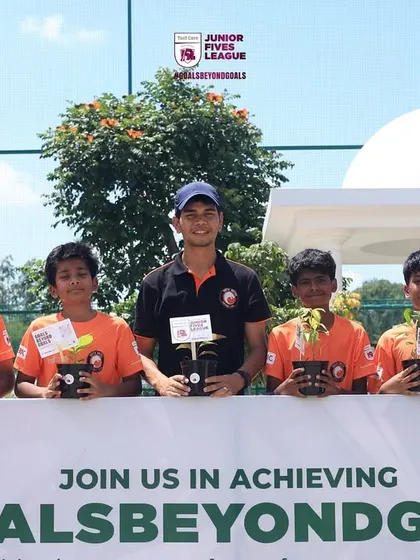 A youth team with their coach and their saplings, ready to make a positive impact.