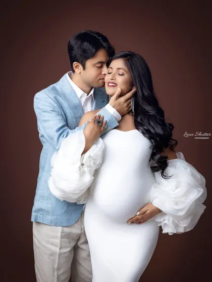 A tender moment shared between the couple. The husband's gentle touch and the wife's serene expression perfectly capture the love and connection of their journey.
