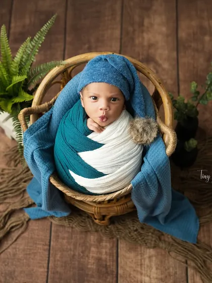 A playful moment captured as this baby makes a funny face. These expressive shots add so much personality to the gallery.