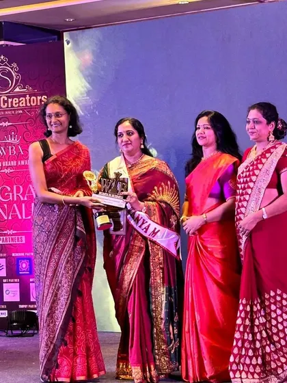 Here I am on stage accepting my award. I share this achievement with every woman entrepreneur who dares to dream and build something from the ground up.