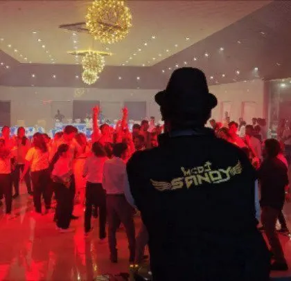 My view from behind the console, looking out at a corporate crowd enjoying the party.