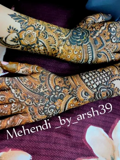 A close-up shot of the intricate patterns on both hands, showcasing the neatness of the lines and the complexity of the design.